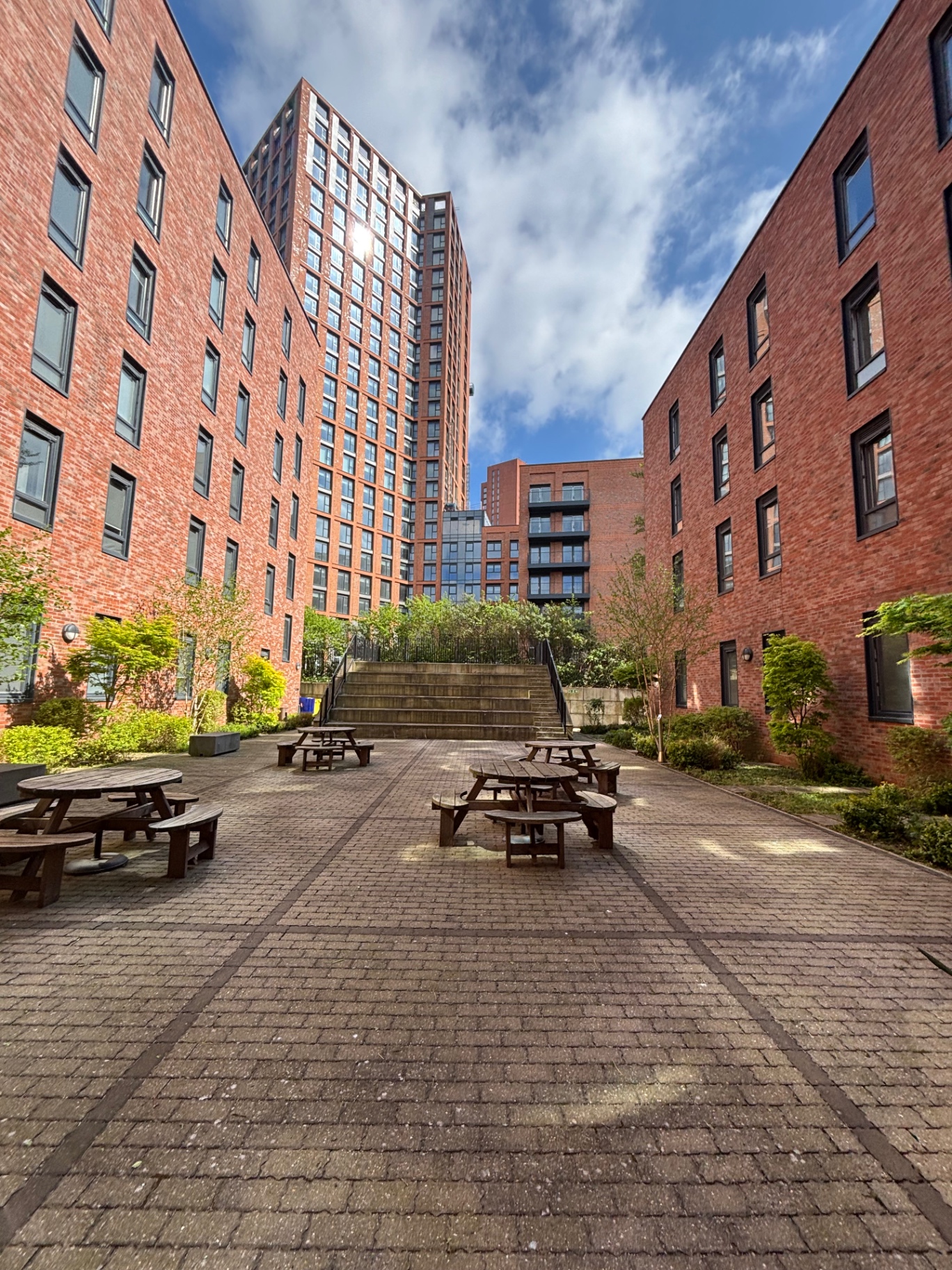 Commercial courtyard maintenance with city tower backdrop
