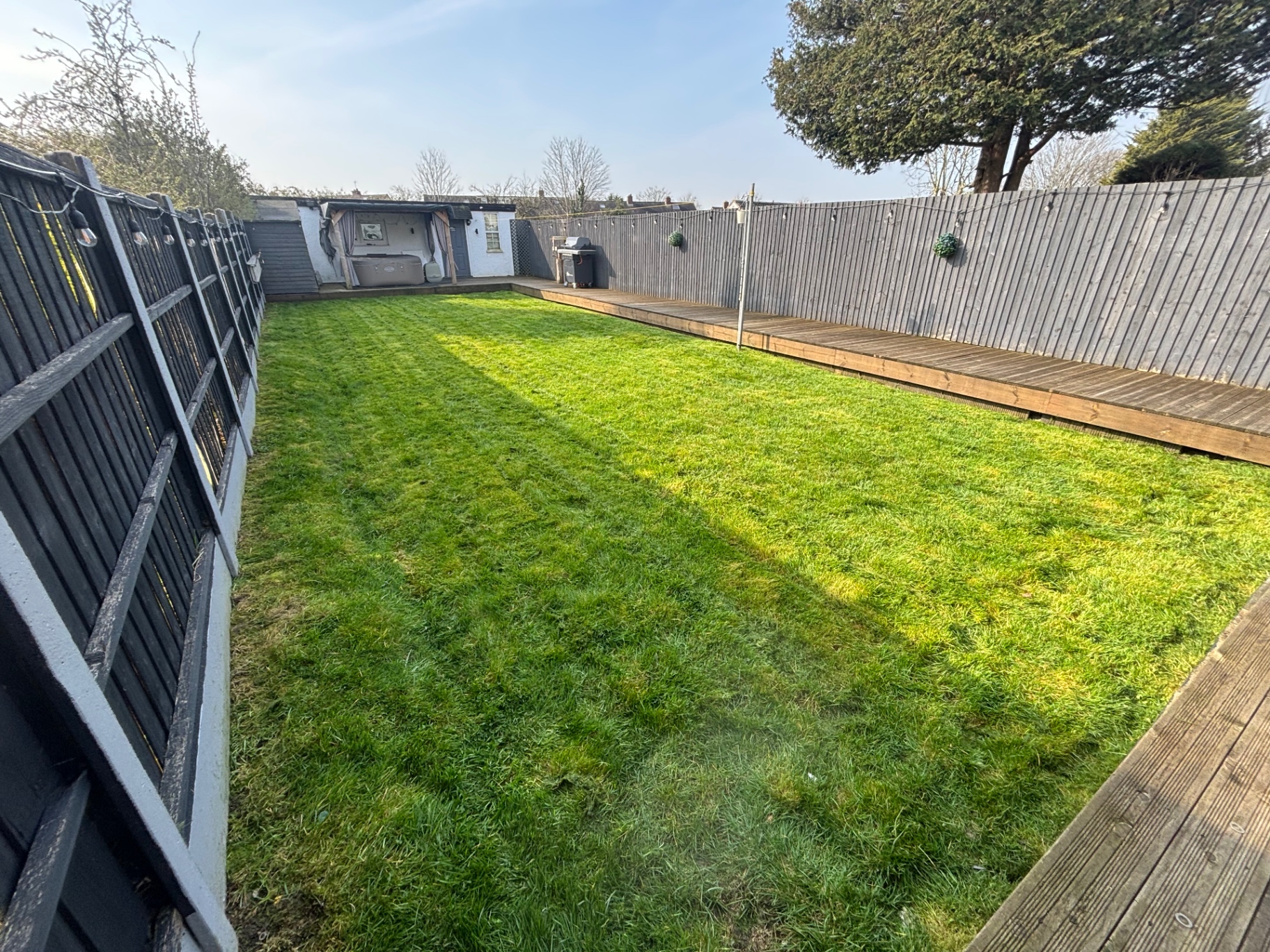 Freshly mowed back garden with neat lawn